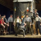 Keith Higham as Billy Bigelow (red shirt) and Stuart Neal as Jigger Craigin (centre) with the chorus and dancers